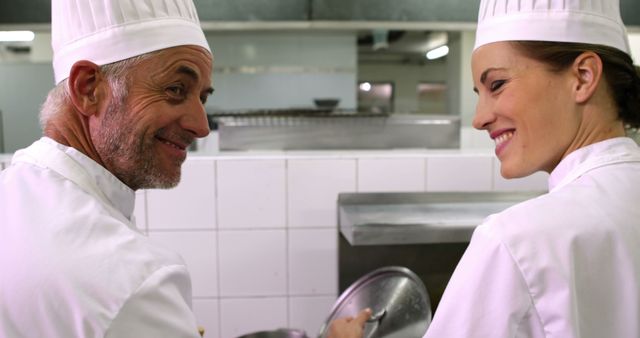 Professional Chefs Smiling and Collaborating in a Kitchen - Download Free Stock Images Pikwizard.com