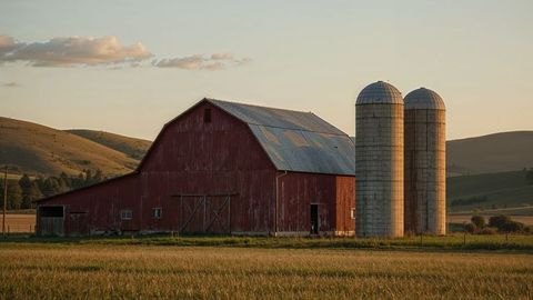 Vintage red barn and twin silos in panoramic nebraska countryside