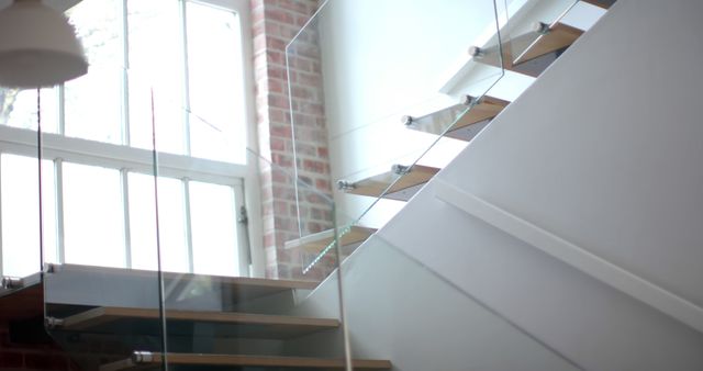 Modern Staircase with Glass Railings and Wooden Steps in Sunlit Room - Download Free Stock Images Pikwizard.com