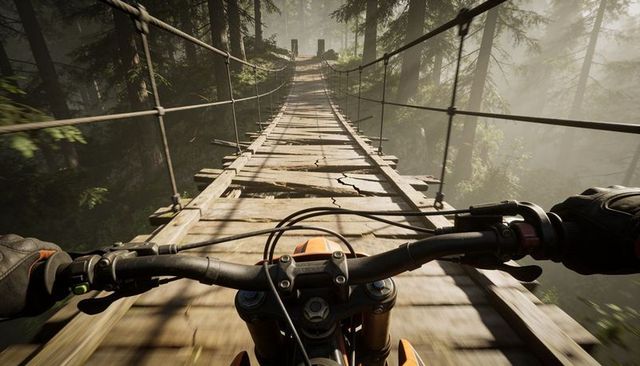 Riding motocross bike across cracked suspension bridge through misty pine forest