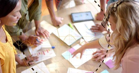 Five professionals collaborating over charts and tablet with digital data overlay