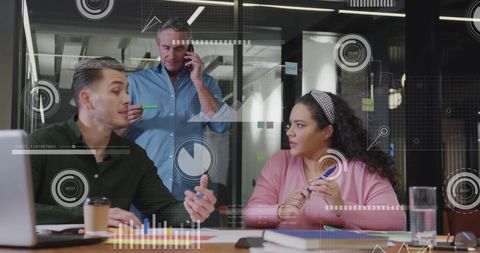 Colleagues Collaborating on Digital Interface Project in Office