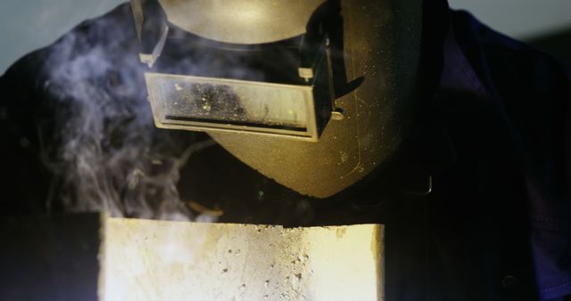 Welder in Protective Gear with Shield Grinding Metal - Download Free Stock Images Pikwizard.com