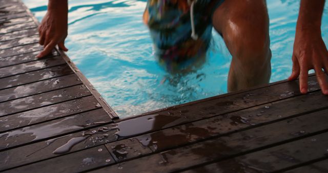 Person Exiting Swimming Pool on Wooden Deck - Download Free Stock Images Pikwizard.com