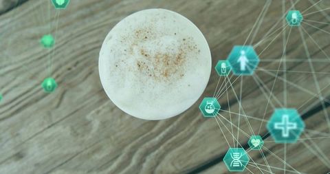 Top-down latte cup displaying medical network hologram overlay on rustic wood table