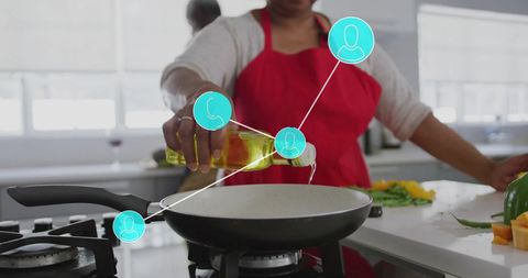Senior african american woman connecting through digital platform while cooking