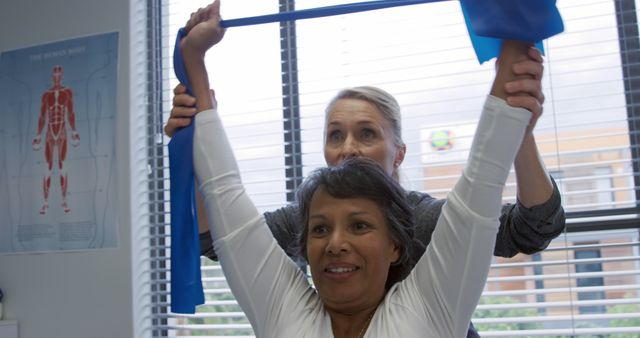 Female Physical Therapist Assisting Senior Woman with Resistance Band - Download Free Stock Images Pikwizard.com