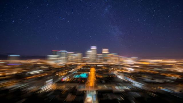 Surreal blurred cityscape at night under starry sky