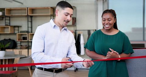 Business Grand Opening Ceremony with Man Cutting Ribbon