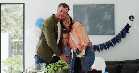 Happy Family Embracing During Birthday Celebration