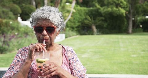 Senior Woman Relaxing Outdoors with Refreshing Drink - Download Free Stock Images Pikwizard.com