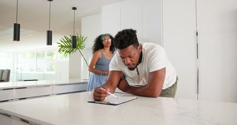 Couple Engaging in Planning Activity at Home Setting