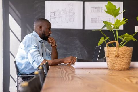 Architect Contemplating Designs in Modern Office Space