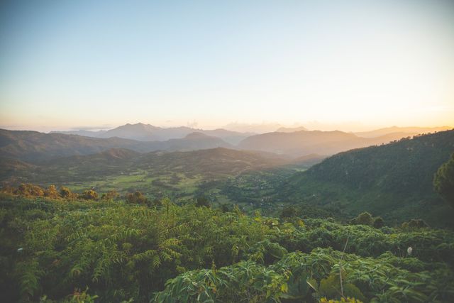 Lush green hills with tranquil valleys during sunset. Ideal for nature, tourism, outdoor activities, and travel promotions. Perfect for backgrounds on websites, travel blogs, and adventure projects.