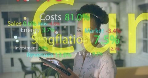 Holding tablet analyzing ar economic dashboard overlay in modern coworking office