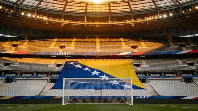 Bosnia and herzegovina flag draping central stadium stands behind soccer goal at golden hour