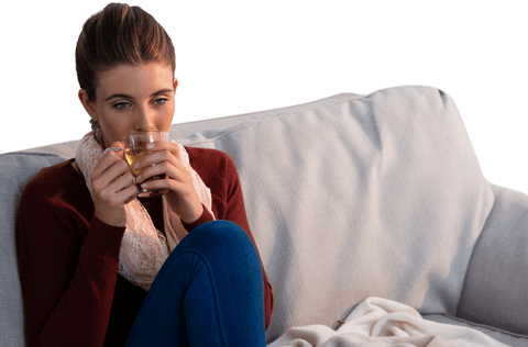 young woman enjoying transparent lemon tea on comfortable sofa - Download Free Stock Videos Pikwizard.com