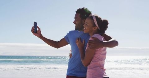 Couple Taking Selfie on Sunny Beach with Ocean View