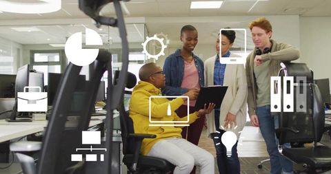 Diverse team collaborating around tablet in modern open office with analytics icons