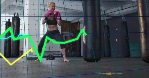 Female athlete boxing with heavy bags and performance data overlay, intense training
