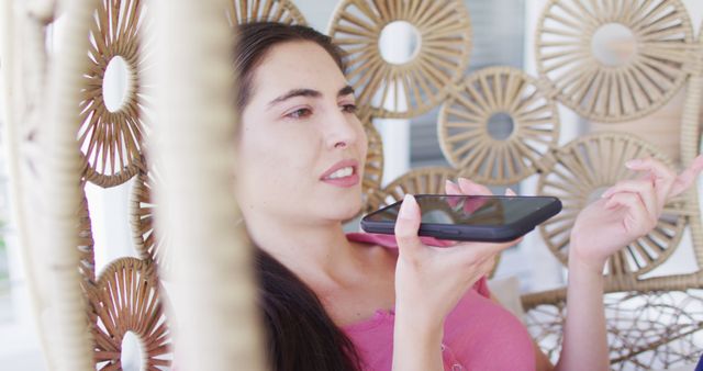 Young Woman Using Smart Home Voice Assistant on Tablet in Cozy Rattan Chair - Download Free Stock Images Pikwizard.com