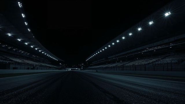 Empty night race circuit with floodlights and grandstands