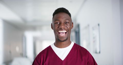 Smiling African American Male Doctor in Hospital Corridor