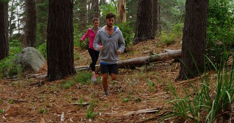 couple jogging on forest trail promoting active outdoor lifestyle - Download Free Stock Images Pikwizard.com