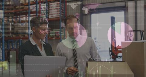 Caucasian Business Colleagues Analyzing Digital Data in Warehouse