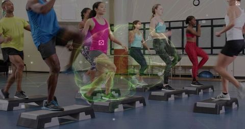 High-energy group step aerobics class exercising with holographic fitness data overlay