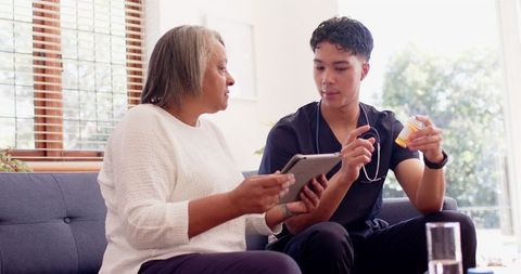 Physiotherapist Utilizing Tablet for Elderly Patient Care - Download Free Stock Images Pikwizard.com