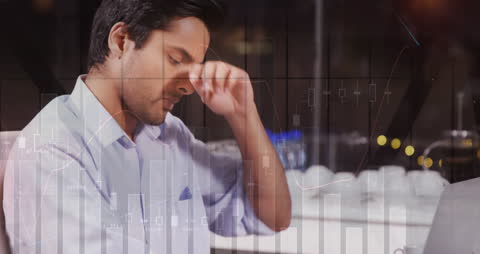 Businessman Analyzing Stock Market Data with Financial Graphs