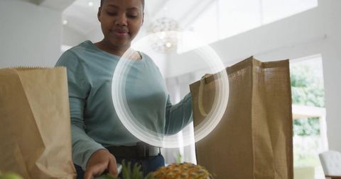 Woman unpacking groceries on kitchen island fostering healthy lifestyle