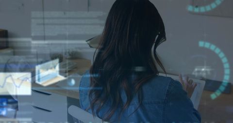 Woman Analyzing Financial Data on Tablet Screen