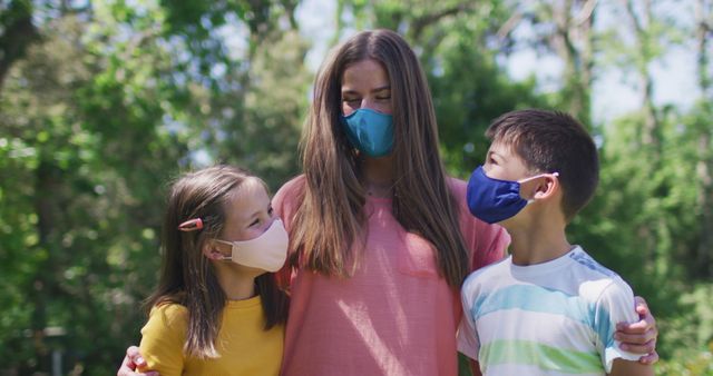 Family Embracing Outdoors Wearing Face Masks in Park - Download Free Stock Images Pikwizard.com