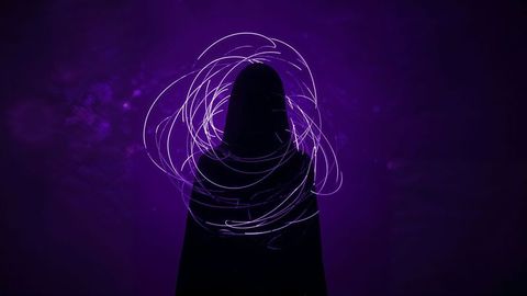 Mystical hooded silhouette with purple light trails