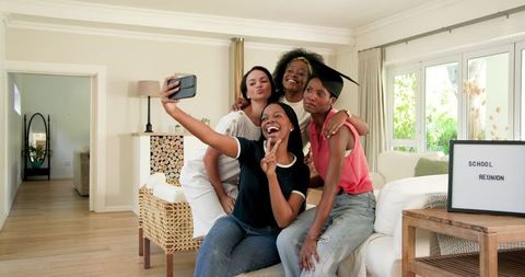 Joyful Friends Taking Selfie During School Reunion Celebration