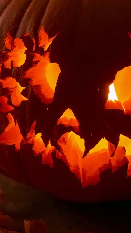 Vertical Jack-o'-Lantern Candle Pulsing, Casting Dancing Shadows on Rustic Wooden Porch