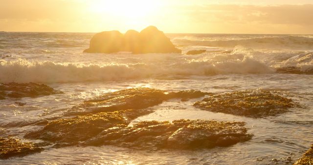 Sunset casts a golden glow over the rocky shoreline, with copy space - Download Free Stock Photos Pikwizard.com