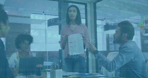 Business Team Analysing Financial Data on Transparent Screen