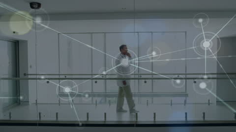 Doctor Using Digital Technology with Network Connections in Hospital Stroll