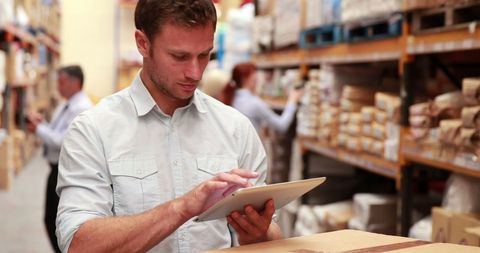 Warehouse Manager Using Tablet to Streamline Operations - Download Free Stock Images Pikwizard.com