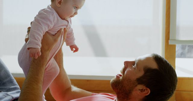 Father Holding Baby Daughter in Bright Living Room - Download Free Stock Images Pikwizard.com