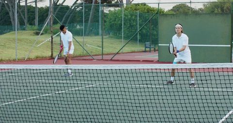 Doubles Partners Preparing at Net on Outdoor Hardcourt Showing Teamwork
