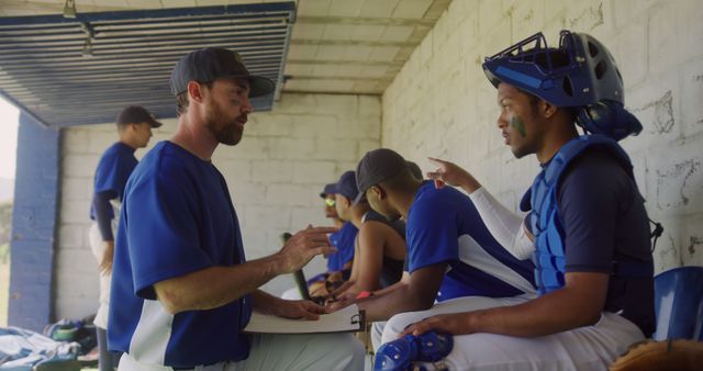 Baseball Coach Giving Instructions to Team Players in Dugout - Download Free Stock Images Pikwizard.com