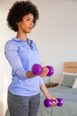 African American Woman Practicing Dumbbell Workout at Home