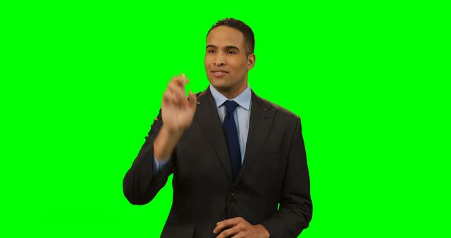Businessman touching invisible screen against green screen