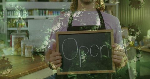 Cafe Worker Holding Open Sign Amidst Pandemic Safety Practices