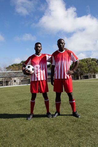 Confident Soccer Players in Red Jerseys on Outdoor Field