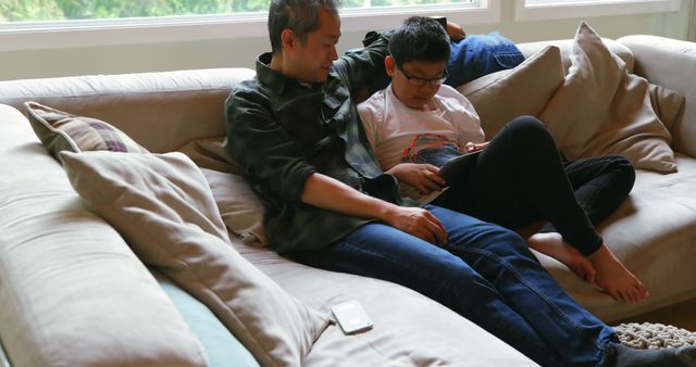 Father and Son Bonding on the Sofa at Home - Download Free Stock Images Pikwizard.com